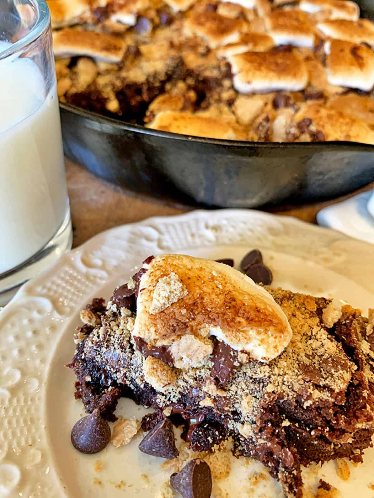 A plate of s'mores brownies and a glass of milk.