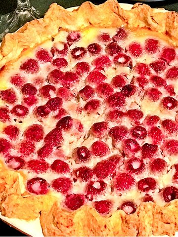 Whole raspberry pie with made with custard.