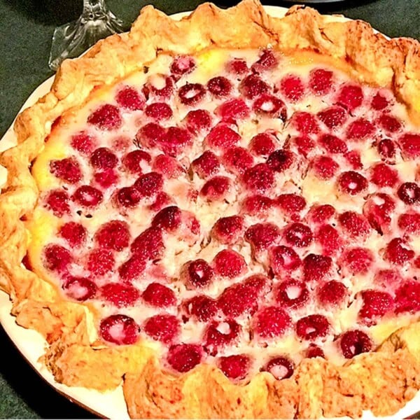 Whole raspberry pie with made with custard.