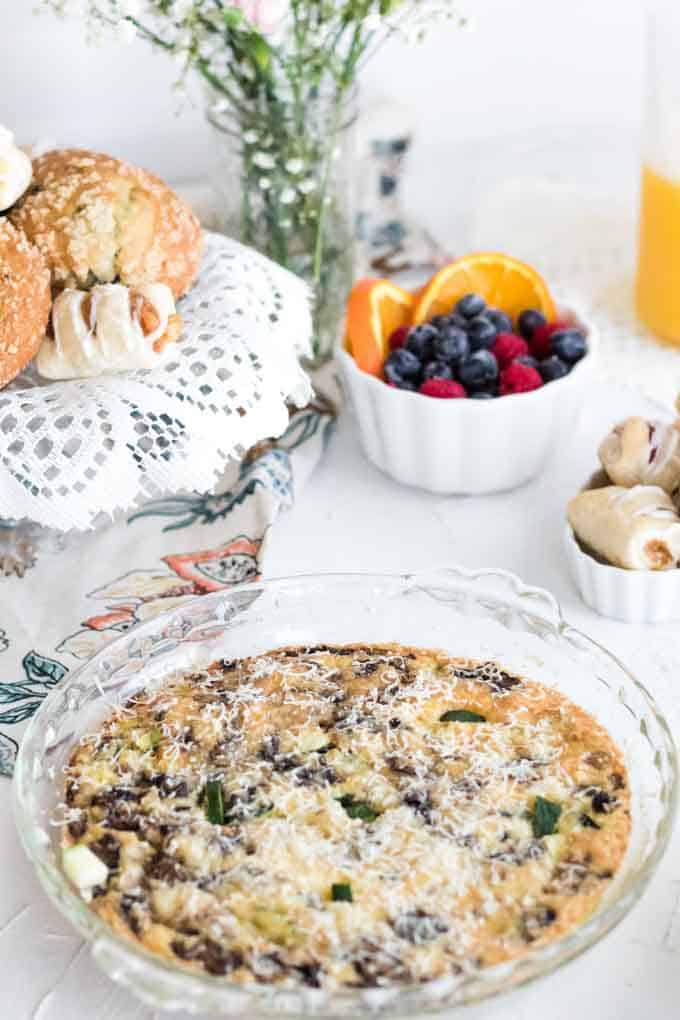 A plate of food on a table, with Quiche and Berries