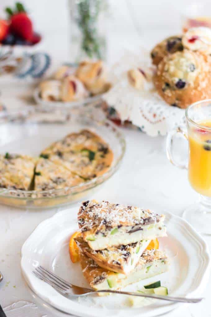 A quiche and glass of orange juice on a table
