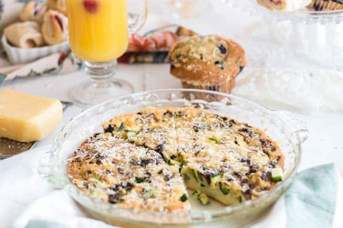 A plate of food on a table, with Quiche and Juice