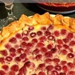 Raspberry custard pie, homemade, with glass of white wine.