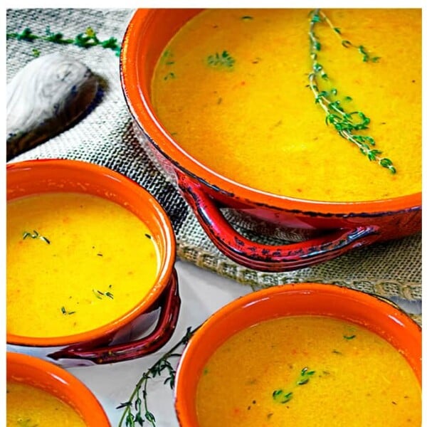 A group of soup bowls garnished with rosemary