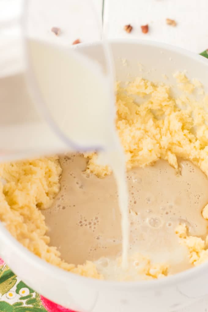 Adding heated milk to coffee cake recipe.