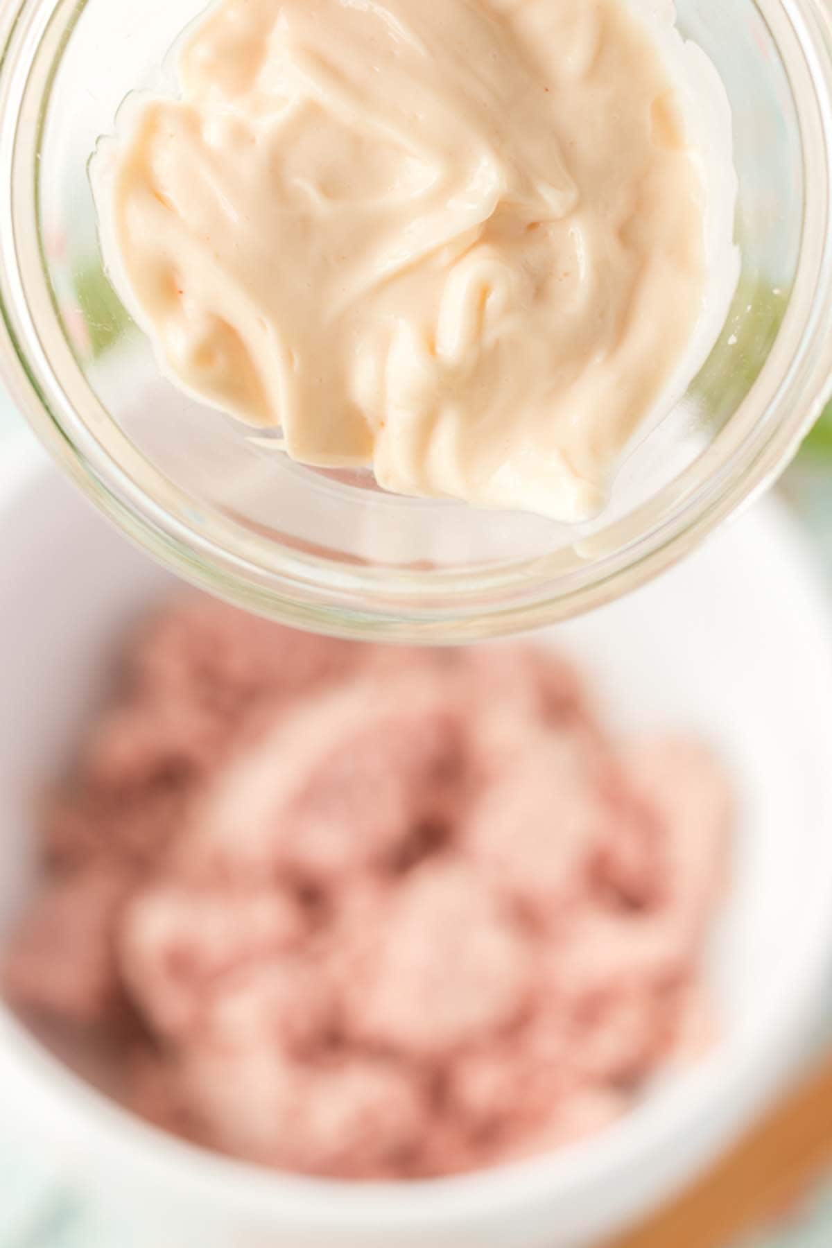 Adding mayo to some deviled ham.