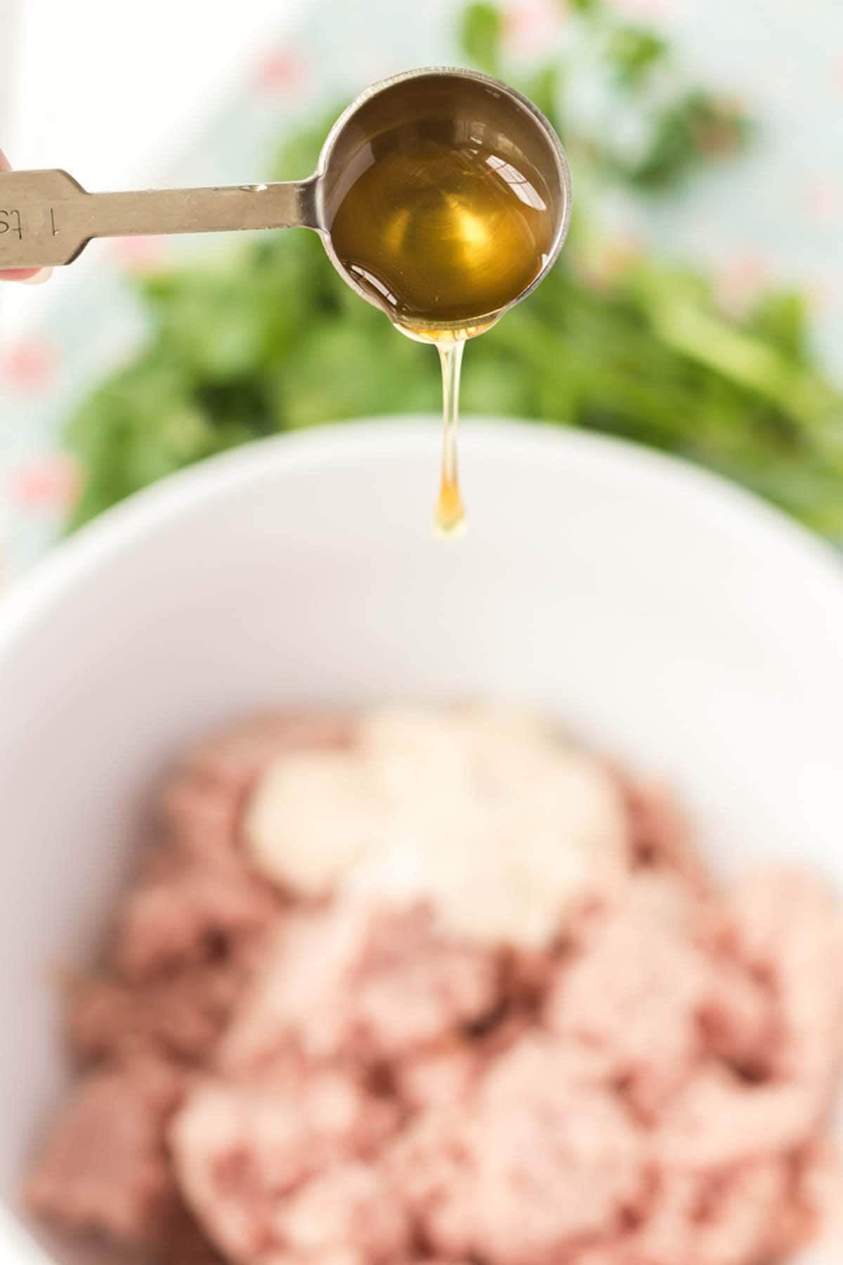 Adding honey to some deviled ham mix.