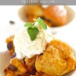 Bowl of crock pot bread pudding with vanilla icre cream and mint leaf.