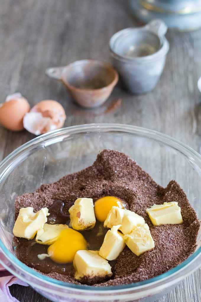 Eggs and butter in a bowl of keto cake batter.