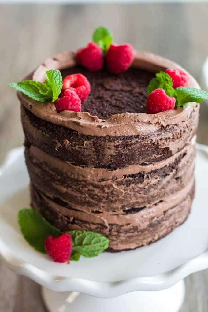 A three-layer chcolate cake with berries on top