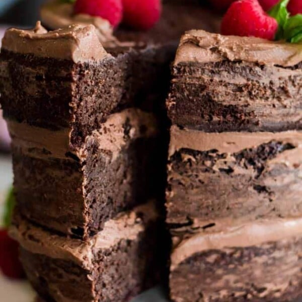 A close up of a chocolate cake with a piece cut from it