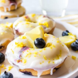 Plate of baked blueberry donuts with lemon donut glaze recipe.