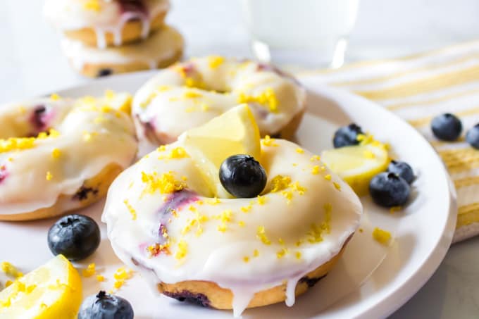 Plate of baked blueberry donuts with lemon donut glaze recipe.