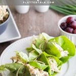 Three lettuce wraps with keto chicken salad on white plate.