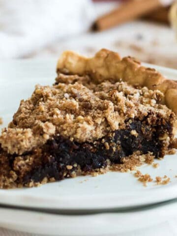 A slice of Shoofly Pie on a white plate.