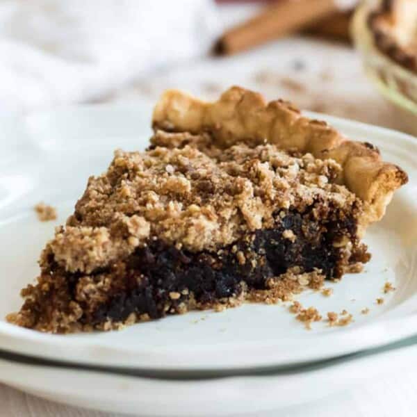 A slice of Shoofly Pie on a white plate.