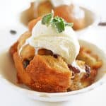 A bowl of bread pudding with vanilla ice cream on top
