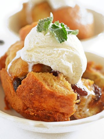 A bowl of bread pudding with vanilla ice cream on top
