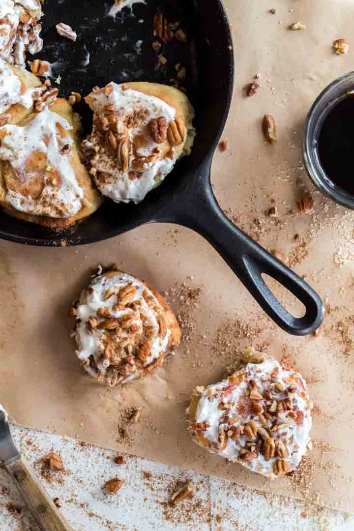 Skillet with keto cinnamon rolls and two rolls.