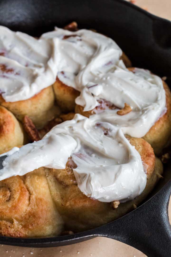 Spreading frosting on keto cinnamon rolls