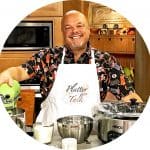 A male chef standing in the kitchen.