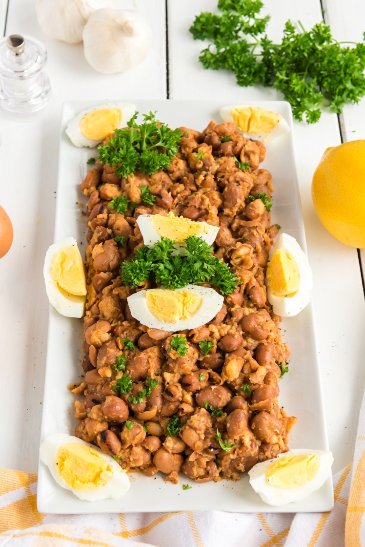 A bunch of food on a plate, with stewed fava beans