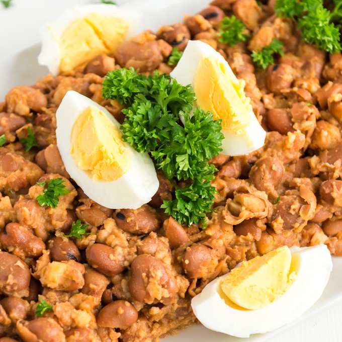 a platter of ful madames with hard boiled eggs and parsely