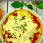 Tomato Pie with Cheese on top in a pie plate.