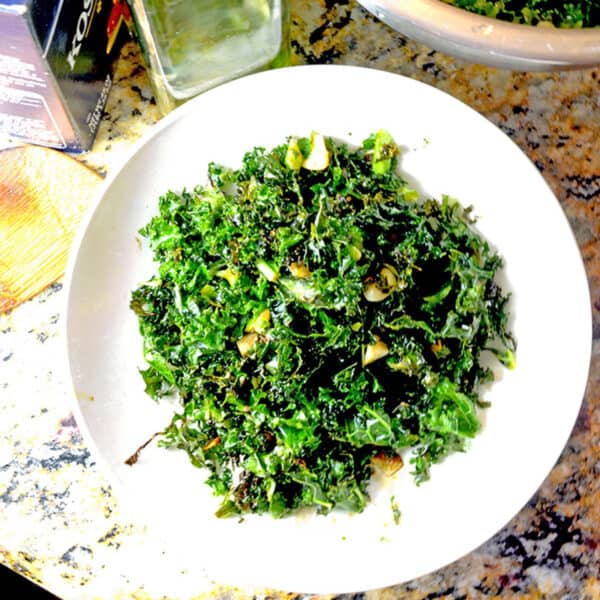 A plate of dark green roasted kale on a white plate.