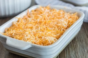 Unbaked chicken wing dip in a cassserole pan.