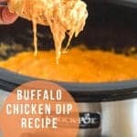 Scoop of Buffalo Chicken Dip from a crock-pot onto a nacho chip.