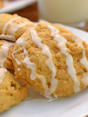 A plate of pumpkin cookies drizzled in icing