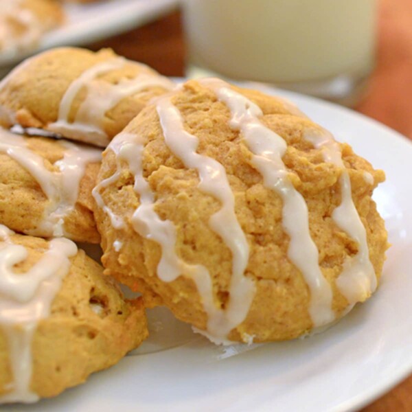 A plate of pumpkin cookies drizzled in icing