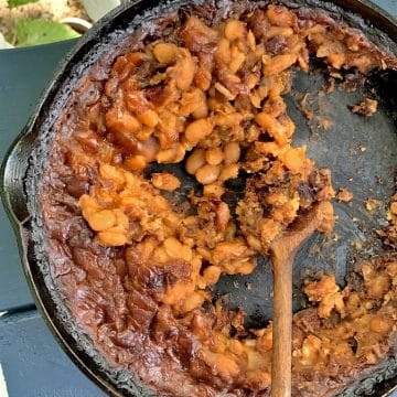 Cast-iron skillet full of instant pot baked beans