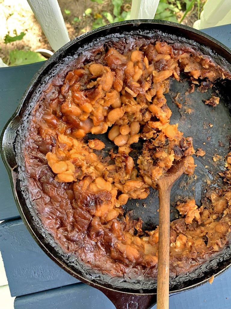 Cast-iron skillet full of instant pot baked beans