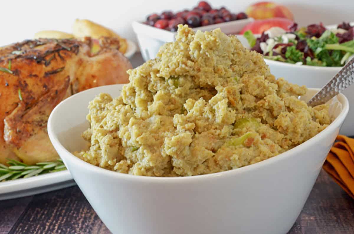 A bowl of southern cornbread dressing in a white bowl.