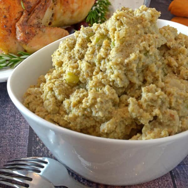 A bowl of cornbread dressing in a white bowl.