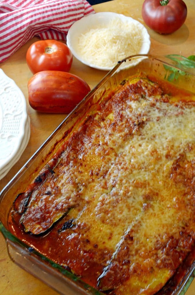 Casserole dish of baked zucchini with parmesan cheese