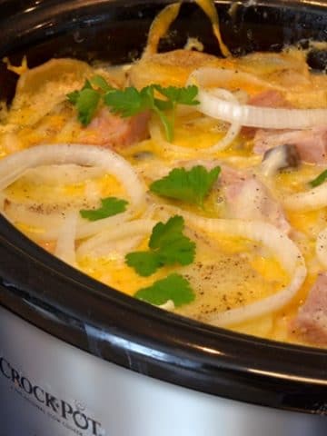 A slow cooker filled with ham and potatoes