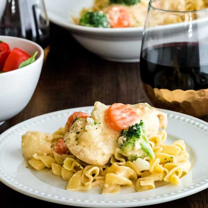 Pair this crockpot chicken recipe with your favoirte red wine! Plate of creamy crock pot chicken with red wine.