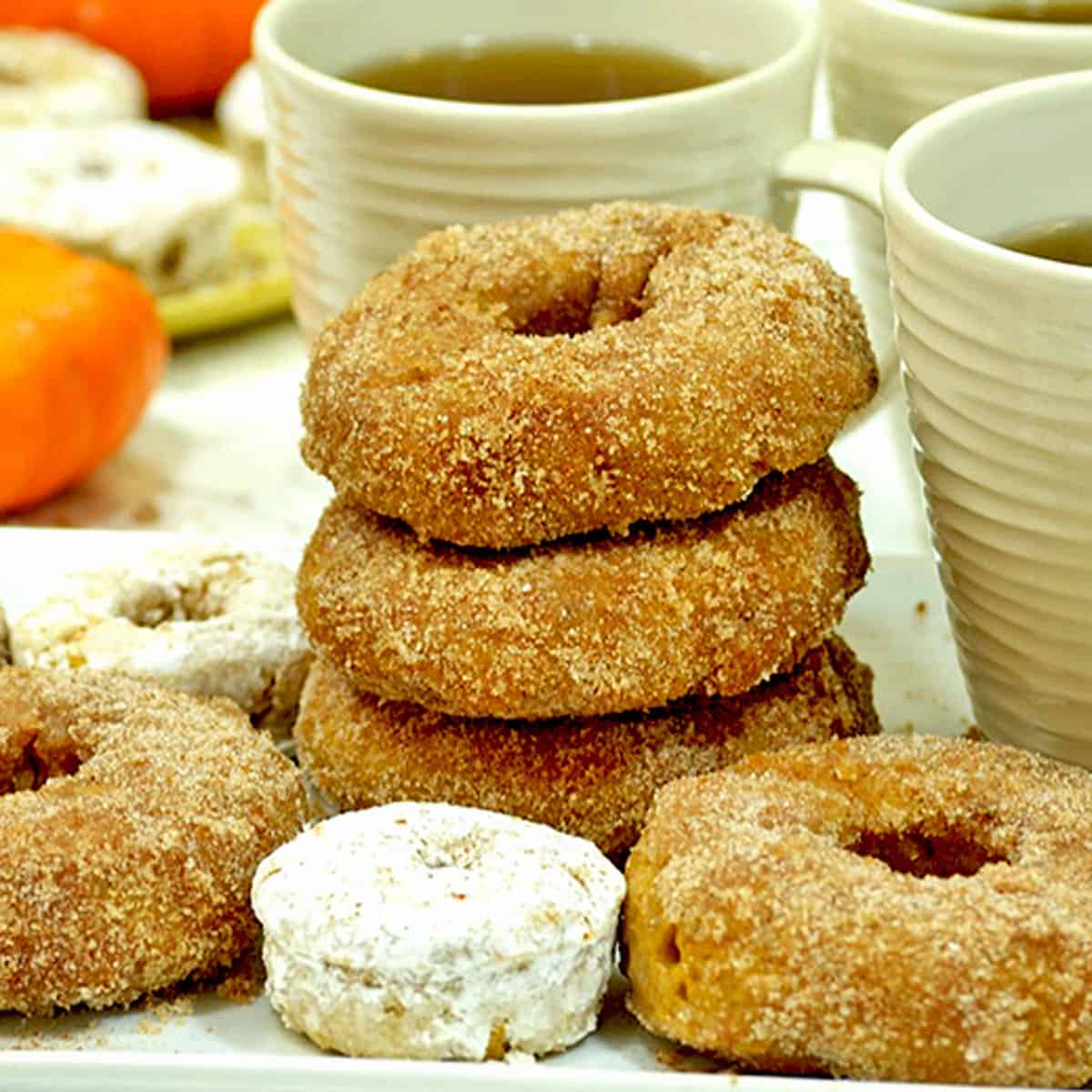 A stack of baked pumpkin donuts.