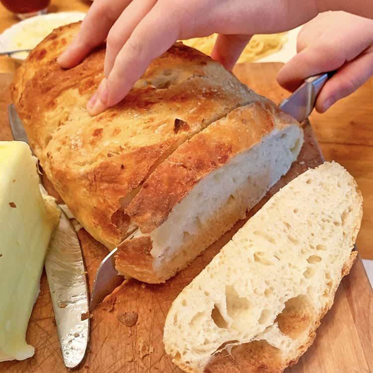 cutting slices of homemade bread on a cutting board