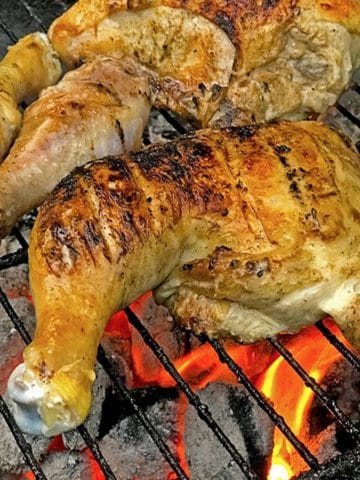 Chickn leg quarter on a hot grill.