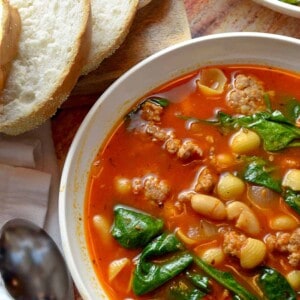 A bowl of sausage and bean soup.