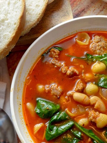 A bowl of sausage and bean soup.