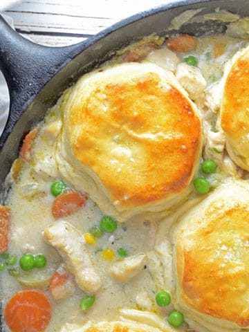 Chicken and Biscuits Pot PIe in a black cast-iron skillet.