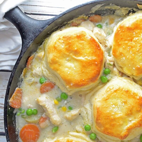 Chicken and Biscuits Pot PIe in a black cast-iron skillet.