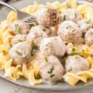 a plate of meatballs over egg noodels