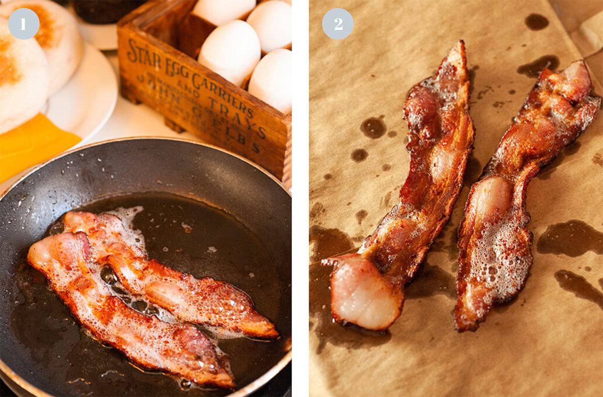 Two slices of bacon frying and then draining on a brown paper bag.
