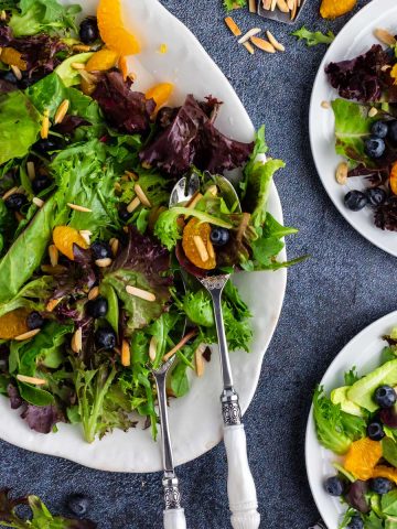 A colorful salad with oranges and blueberries